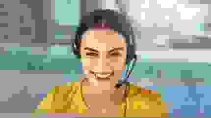 women with a headset on smiling